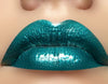 Green shimmer lip gloss with peppermint oil for a cooling, moisturizing and glossy finish.