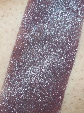 Swatch of Wine Shimmer Eyeshadow; a loose eyeshadow with microfine sparkling particles.